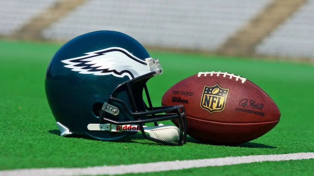 Philadelphia eagles equipment ^ ball and helmet on the green playing field ^ product shot AUGUST 13^ 2015