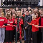 RLC faculty and staff, Banterra Bank representatives, and community members join on the gym floor to celebrate the ribbon cutting for the Banterra Sports Complex. (Photo credit: RLC)