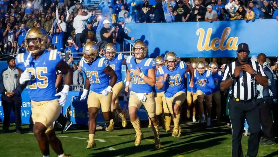 UCLA players run onto the field before an NCAA college football game between the UCLA and the Arizona State^ Nov. 11^ 2023^ in Pasadena^ Calif.