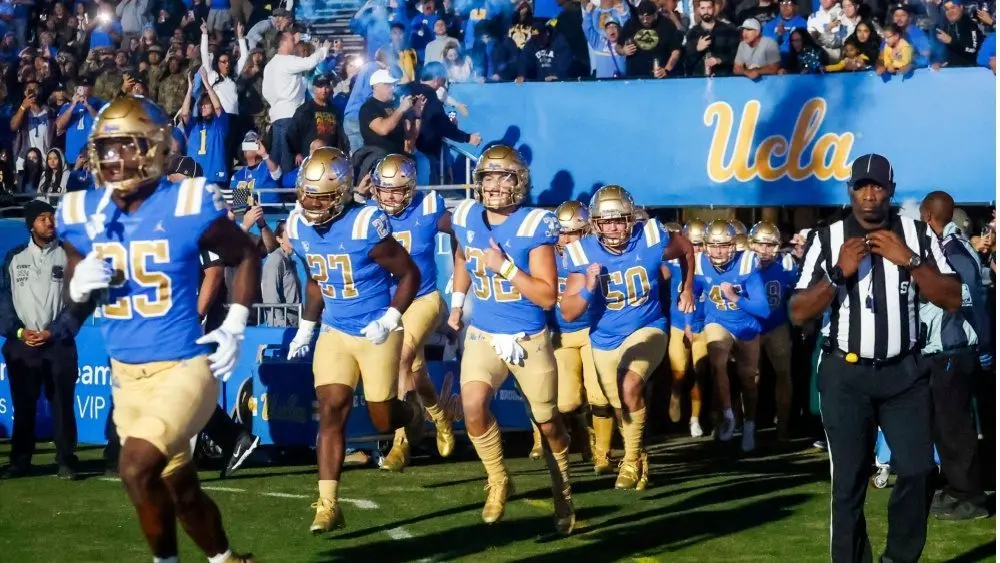 UCLA players run onto the field before an NCAA college football game between the UCLA and the Arizona State^ Nov. 11^ 2023^ in Pasadena^ Calif.
