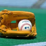 Official Major League Baseball ball and glove on the green field ^ product shot
