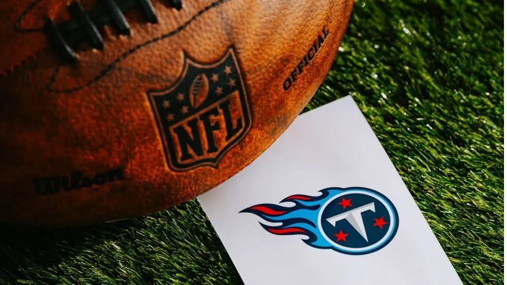 Tennessee Titans NFL team Logo and American football ball on Green Grass. TENNESSEE^ USA^ FEBRUARY 10^ 2025