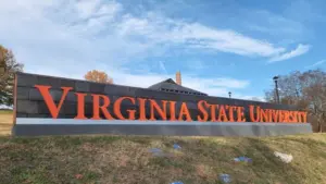 Virginia State University sign on a hill overlooking painted Greek life rocks located in the village of Ettrick in Chesterfield County^ VA. Ettrick^ Virginia USA - November 24^ 2023