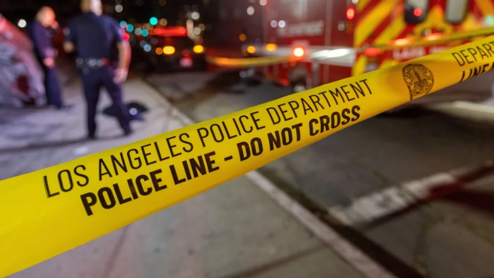 LAPD Los Angeles Police Department Crime Scene Tape with officers and ambulance. Los Angeles California - June 3 2023