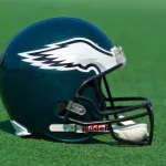 Philadelphia Eagles NFL club helmet on the green playing field ^ product shot