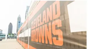 Cleveland Brown's Banner Closeup Leading To The Structural Cityscape Skyline Of Downtown Cleveland. Cleveland^ Ohio/USA - June 1^ 2019