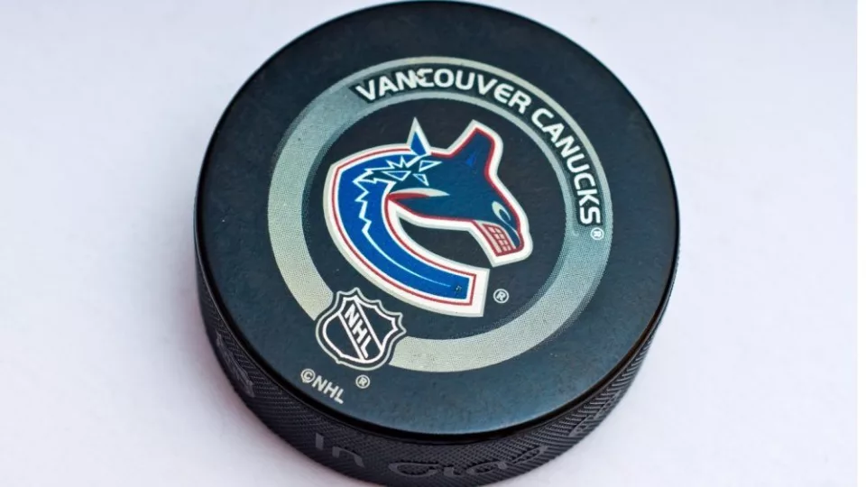 Official Vancouver Canucks game puck on the ice ^product shot