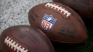 NLF footballs are displayed before an NFL football game between the Los Angeles Rams and the Seattle Seahawks at SoFi Stadium Sunday Nov. 16^ 2025^ in Inglewood^ Calif.