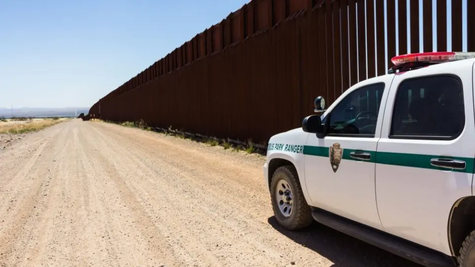 Police car stopped near the border fence of the USA . Arizona^ USA - June 28^ 2016