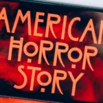 Screensaver with the 'American horror story' logo on a smartphone on toned background