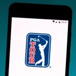 photo illustration the PGA Tour logo is displayed on a smartphone.