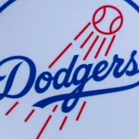 The emblem of the Los Angeles Dodgers baseball club and a baseball. September 26^ 2022^ Cooperstown^ New York