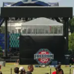 WASHINGTON^ DC - June 7^ 2026: Tourists look on the Ultimate Fighting Championship's octagon set up on the White House South Lawn for an event scheduled for June 14.