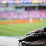 Baseball glove on the wall with a major league stadium in the background