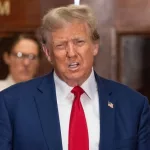 Former President Donald Trump speaks to the press before closing arguments at his civil fraud trial at State Supreme Court in New York on January 11^ 2024