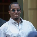 Sean “Diddy” Combs exiting the Crosby Street Hotel and heading to a waiting line of black SUV's surrounded by paparazzi and flanked by security. Lower Manhattan NYC^ New York / USA - July 24^ 2019