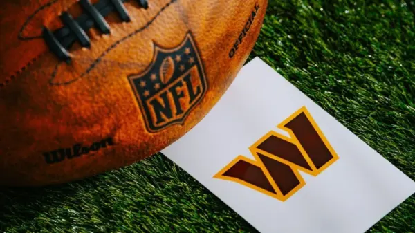 Washington Commanders NFL team Logo and American football ball on Green Grass.