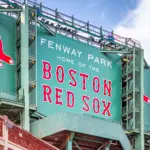 Vew of the historic architecture of the Famous Fenway Park Stadium in Boston^ MA^ USA showcasing its huge sign^ old brick walls^ and entrances on Lansdowne street. Boston^ MA^ USA - March 1^ 2023