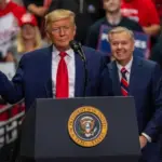 Senator Lindsey Graham smiles behind President Trump at the rally in the Bojangle's Coliseum Charlotte^ North Carolina - 2 March 2020