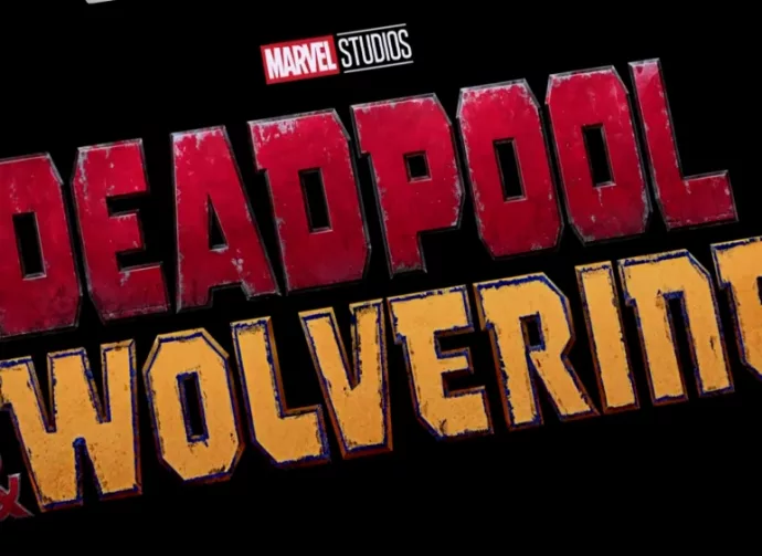 Logo of Deadpool and Wolverine movie on phone screen with movie trailer on the background on TV screen.