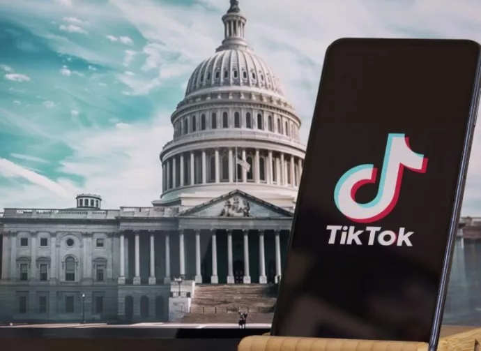 TikTok sign is sharp in the foreground^ while American Congress building is blurred in the background^ concept for TikTok ban in the United States^ USA^ March 8^ 2024