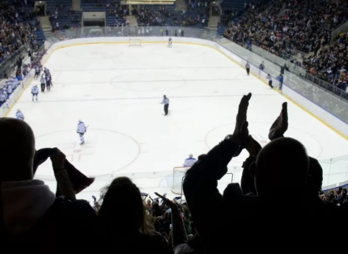 hockey fans applaud at ice hockey stadium