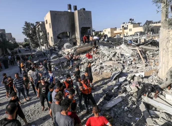 Palestinians evacuate wounded after an Israeli airstrike in Rafah refugee camp^ southern Gaza Strip^ on October 13 2023.