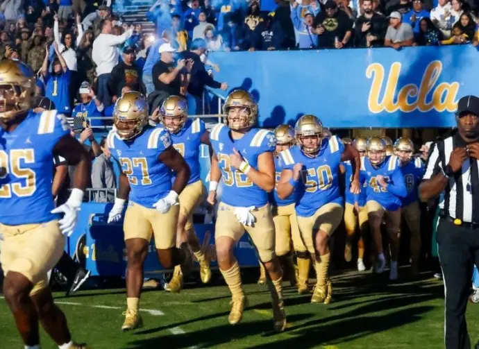 UCLA players run onto the field before an NCAA college football game between the UCLA and the Arizona State^ Nov. 11^ 2023^ in Pasadena^ Calif.
