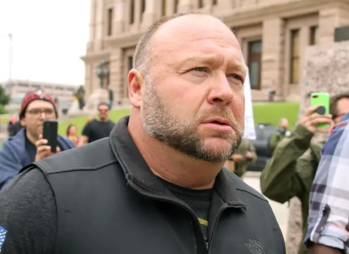 Alex Jones^ flanked by bodyguards^ leaves a rally protesting Covid-19 stay at home orders at the Capitol that was heavily promoted by his Infowars website. Austin^ Tx/USA - Apr. 18^ 2020