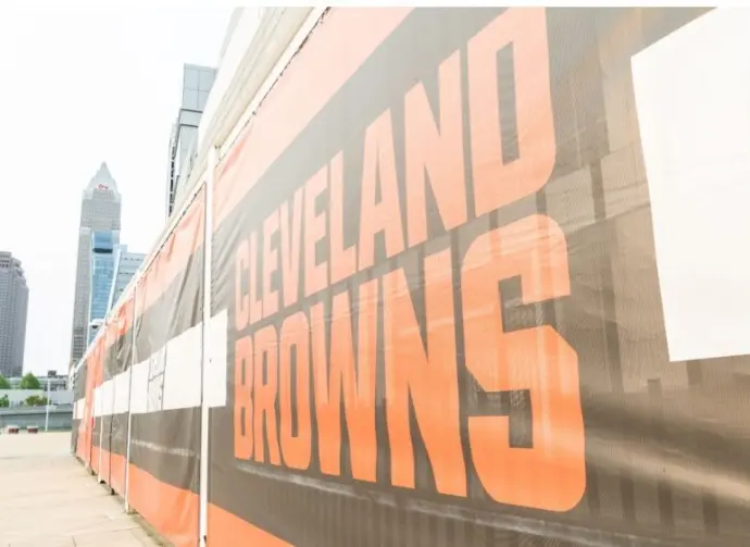 Cleveland Brown's Banner Closeup Leading To The Structural Cityscape Skyline Of Downtown Cleveland. Cleveland^ Ohio/USA - June 1^ 2019