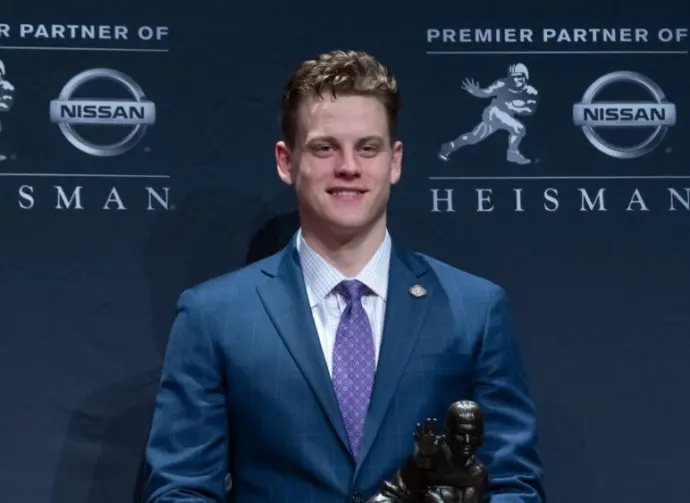 Quarterback Joe Burrow of the LSU Tigers winner of the 85th annual Heisman Memorial Trophy poses with trophy at the Marriott Marquis Hotel New York^ NY - December 14^ 2019