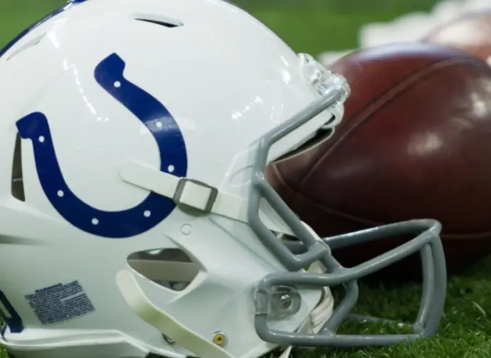 Indianapolis Colts helmet shown on field next to football; Colts host the Oakland Raiders on 9/29/19 at Lucas Oil Stadium in Indianapolis IN-USA