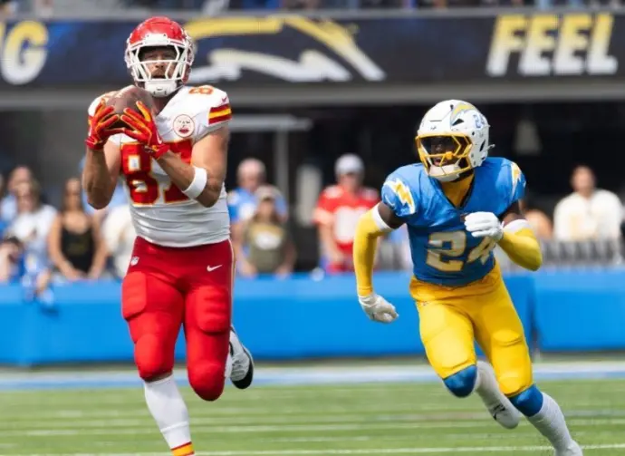 KC Chiefs tie end Travis Kelce #87 catches a pass next to LA Chargers safety AJ Finley #24 during an NFL football game at SoFi Stadium^ Aug. 17^ 2024^ in Inglewood^ Calif.