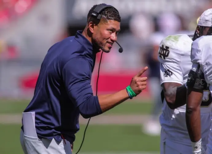 Notre Dame's Marcus Freeman congratulates his team after a score at Razorback Stadium^ Fayetteville^ AR. Sept 27^ 2025