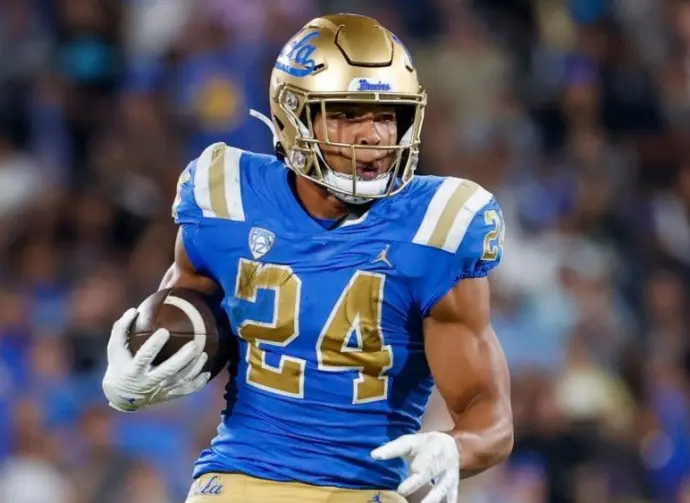 UCLA running back Zach Charbonnet (24) escapes a tackle-attempt by Washington linebacker Alphonzo Tuputala (11) during an NCAA college football game Friday^ Sept. 30^ 2022^ in Pasadena^ Calif.