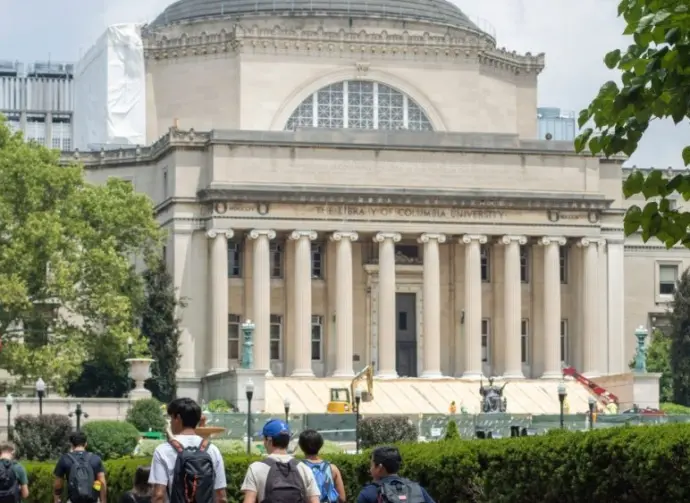 Students at the Columbia University campus on the Upper West Side of Manhattan. Steps of the Low Memorial Library in the background. New York^ NY^ USA - July 8^ 2022: