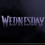 TV on black wall. TV screen playing Netflix series 'Wednesday' trailer