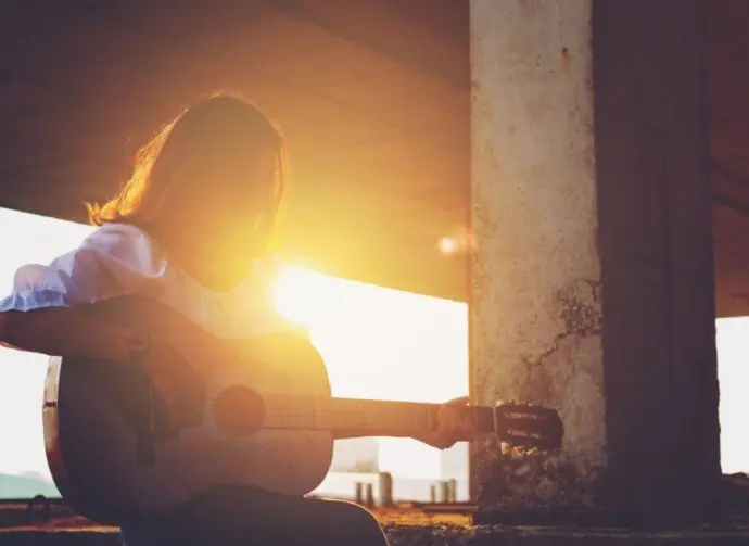 Candid silhouette woman chill play acoustic guitar musician Artists female sad mood activity music at balcony flare lighting sunset background