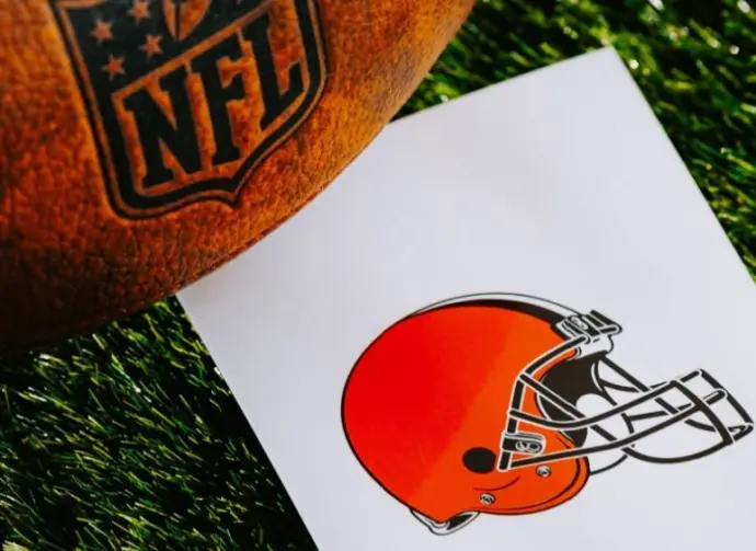 Cleveland Browns NFL team Logo and American football ball on Green Grass. CLEVELAND^ USA^ FEBRUARY 10^ 2025