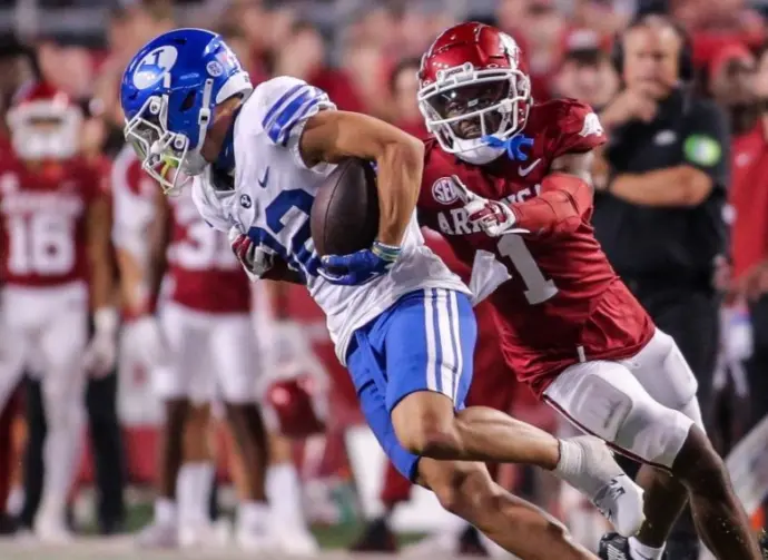NCAA Football^ BYU 38:31 Ark- Cougars WR Parker Kingston (82) catches a pass fights off Razorbacks DB Lorando Johnson (1) the game at Razorback Stadium^ Fayetteville^ AR. Sept 16^ 2023