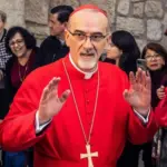 Cardinal Pierbattista Pizzaballa^ Latin Patriarch of Jerusalem^ greets the crowd as he leaves the Church of the Nativity after the Christmas celebrations. Bethlehem^ West Bank^ December 25^ 2025