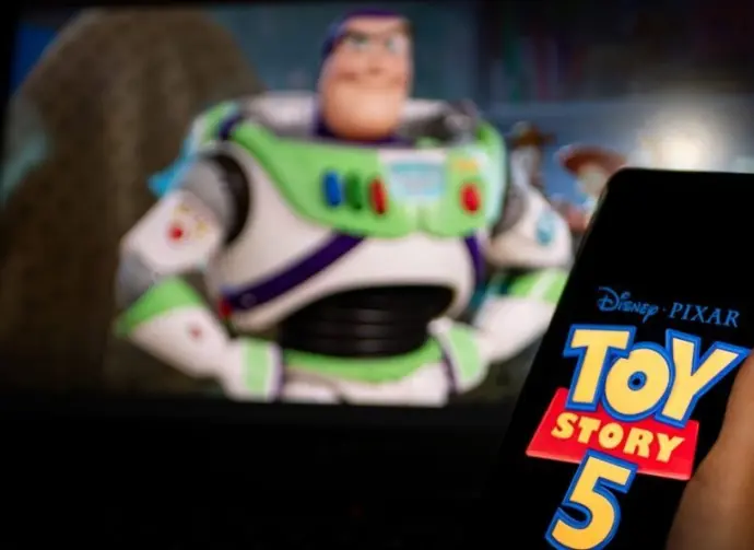 New Disney film Toy Story 5. A man's hand holds a phone with a poster of the new cartoon Toy Story 5 by Pixar. Moscow November 2025.