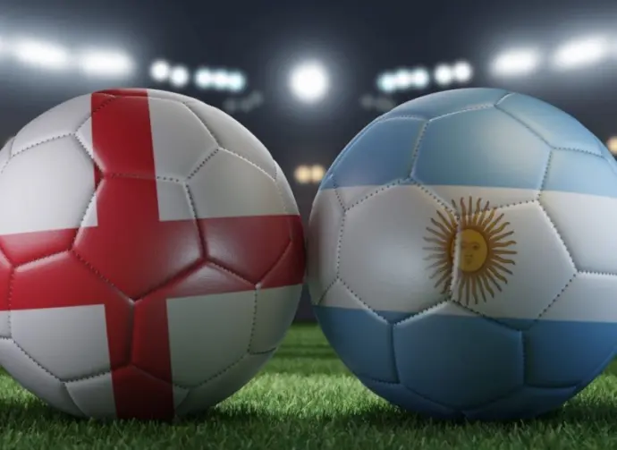 Two soccer balls in flags colors on a stadium blurred background. England vs Argentina. 3D image.