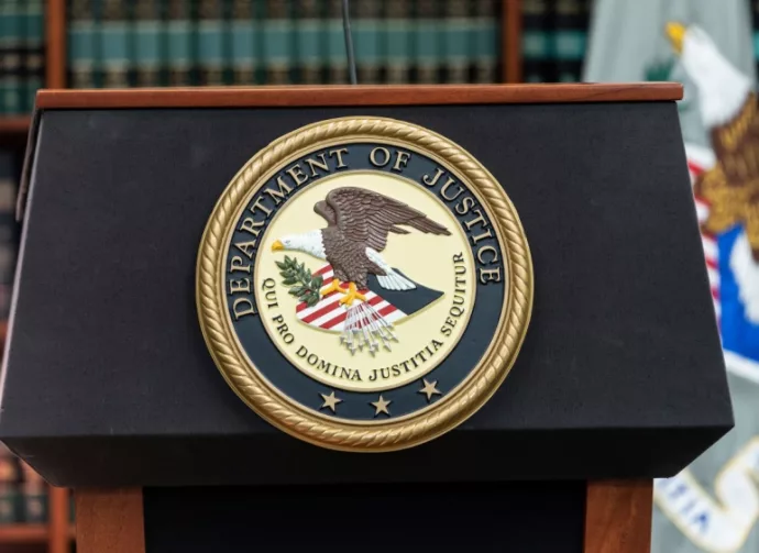 Seal of Justice Department seen during press conference at US Attorney Office library