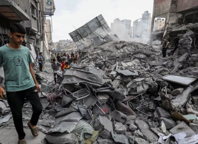 People search the Khan Yunis municipality building after an Israeli air strike^ in the city of Khan Yunis^ southern of the Gaza Strip^ October 10^ 2023.