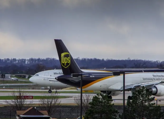 Louisville^ KY—March 6^ 2018 air cargo planes taxi to end of runway prior to take off