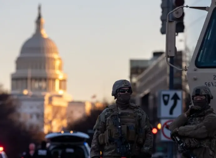 Members of the National Guard patrol the area surrounding the outskirts of the Capitol Building on January 19^ 2021^ in Washington D.C.