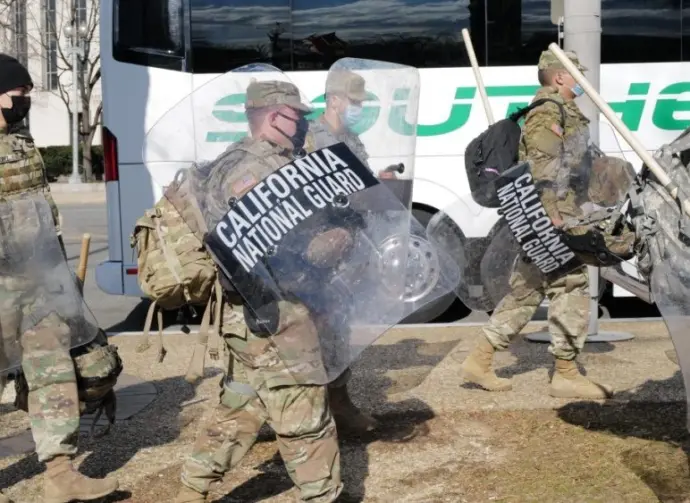 California National Guard troops prepare to board a bus for their return home after completing their assignment in Washington during the inauguration. Washington^ DC – January 22^ 2021