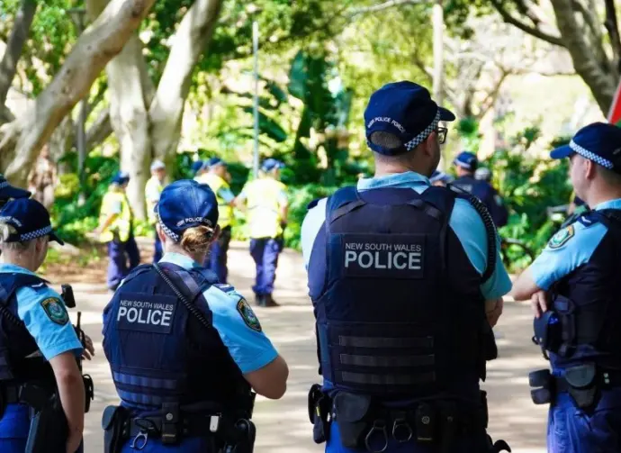 Crime in Sydney Australia. Close up of a NSW Police officers uniform sleeve patch and his communication device. Sydney^ NSW Australia - October 6 2024