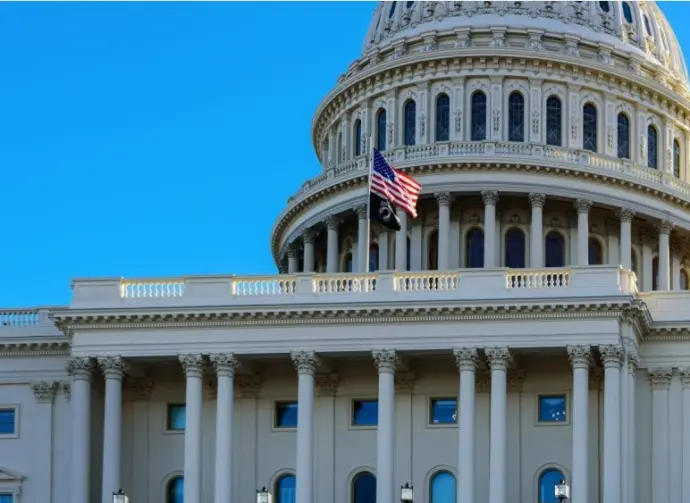 Close-up of the United States flag in front of the Capitol Building's dome in the morning^ Washington^ D.C.
